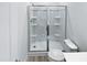 This bathroom features an enclosed shower and toilet with white tiling and modern fixtures at 1336 Weavers Trace Dr, Zebulon, NC 27597