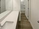 Modern bathroom featuring a white vanity and sink, with a shower and toilet in the background at 1336 Weavers Trace Dr, Zebulon, NC 27597