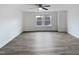 Bright bedroom with wood-look floors, a ceiling fan, and a window overlooking the neighborhood at 1336 Weavers Trace Dr, Zebulon, NC 27597