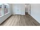 Bright bedroom with wood-look floors, a closet, and a window overlooking the neighborhood at 1336 Weavers Trace Dr, Zebulon, NC 27597