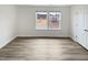 Bright bedroom with wood-look floors, a large window overlooking the neighborhood, and neutral walls at 1336 Weavers Trace Dr, Zebulon, NC 27597