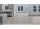 An eat-in kitchen area features many windows and gray cabinetry at 1336 Weavers Trace Dr, Zebulon, NC 27597