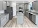 An open-concept kitchen boasts stainless appliances and light gray cabinetry at 1336 Weavers Trace Dr, Zebulon, NC 27597