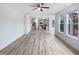 Open concept living room features large windows, light gray flooring, and flows into the kitchen at 1336 Weavers Trace Dr, Zebulon, NC 27597