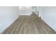 Open loft area with light wood-look floors, white walls, and plenty of natural light from nearby windows at 1336 Weavers Trace Dr, Zebulon, NC 27597