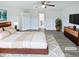The main bedroom features a ceiling fan, ensuite, and neutral decor at 1336 Weavers Trace Dr, Zebulon, NC 27597
