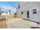 Back of home showing siding and small, new wooden deck adjacent to a concrete patio at 1420 Springshire Ct, Raleigh, NC 27610