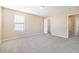 Spacious carpeted bedroom with a closet and lots of natural light from the window at 1420 Springshire Ct, Raleigh, NC 27610