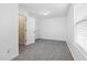 Bright bedroom featuring a large window, neutral carpet, and ample closet space at 1420 Springshire Ct, Raleigh, NC 27610