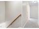 Hallway with stairs and carpeted floor showing access to rooms with neutral walls at 1420 Springshire Ct, Raleigh, NC 27610