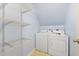 The functional laundry room includes a washer, dryer, and ample wire shelving at 1420 Springshire Ct, Raleigh, NC 27610