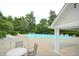 Community pool featuring multiple lounge chairs surrounded by green foliage at 1420 Springshire Ct, Raleigh, NC 27610