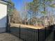 Spacious fenced-in backyard with a view of the surrounding trees at 145 Plantation Dr, Youngsville, NC 27596