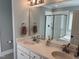 Bathroom with double vanity, framed mirrors and glass enclosed shower at 145 Plantation Dr, Youngsville, NC 27596