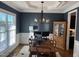 Home office with hardwood floors, a statement light fixture and plenty of natural light with an adjacent view of the kitchen at 145 Plantation Dr, Youngsville, NC 27596