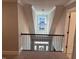 The landing features a striking light fixture and a staircase leading to the entry at 145 Plantation Dr, Youngsville, NC 27596