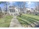 Enjoy a sprawling backyard featuring a stone walkway, mature trees, and fire pit at 1600 Patterson Grove Rd, Apex, NC 27502