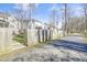 View of a wooden fence and exterior pathway bordering the back of the property line on a sunny day at 1600 Patterson Grove Rd, Apex, NC 27502