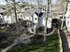 Backyard aerial view with a stone patio, fire pit, screen porch, and greenhouse at 1600 Patterson Grove Rd, Apex, NC 27502