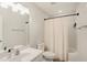 Clean bathroom with a shower-tub combo and a light vanity with modern fixtures at 1600 Patterson Grove Rd, Apex, NC 27502