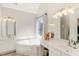 Bright bathroom featuring double sinks, a corner tub under a window, and a separate shower area at 1600 Patterson Grove Rd, Apex, NC 27502
