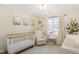 Bright Bedroom featuring neutral walls, carpet flooring, and a crib near a sun-filled window at 1600 Patterson Grove Rd, Apex, NC 27502