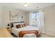 Inviting bedroom with a queen-sized bed, neutral decor, and a large window providing natural light at 1600 Patterson Grove Rd, Apex, NC 27502