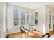 Bright breakfast nook area with a glass table and lots of natural light from large windows at 1600 Patterson Grove Rd, Apex, NC 27502