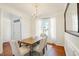 Charming dining area illuminated by large windows, showcasing a rustic wood table and elegant decor at 1600 Patterson Grove Rd, Apex, NC 27502