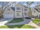 Charming two-story home featuring a well-manicured lawn, brick walkway, and attached two car garage at 1600 Patterson Grove Rd, Apex, NC 27502