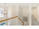 Elegant foyer with a large window, chandelier, and staircase with wooden handrail and white balusters at 1600 Patterson Grove Rd, Apex, NC 27502