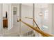 Bright foyer featuring a pendant light fixture, staircase with wooden handrail and access to multiple rooms at 1600 Patterson Grove Rd, Apex, NC 27502