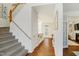 Bright and airy foyer features hardwood floors, carpeted stairs, and view to living spaces at 1600 Patterson Grove Rd, Apex, NC 27502