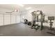 Spacious two-car garage with rubber flooring and a home gym setup at 1600 Patterson Grove Rd, Apex, NC 27502