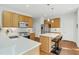 Bright kitchen featuring white countertops, stainless steel appliances, and an island with seating at 1600 Patterson Grove Rd, Apex, NC 27502