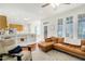 Open-concept living area with hardwood floors, a comfortable couch, and built-in shelving, seamlessly connecting to the kitchen at 1600 Patterson Grove Rd, Apex, NC 27502