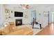 Cozy living room featuring built-in shelving, a fireplace, a comfortable couch, and a ceiling fan at 1600 Patterson Grove Rd, Apex, NC 27502