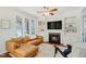 Inviting living room featuring a fireplace, built-in shelving, and a comfortable leather sectional sofa at 1600 Patterson Grove Rd, Apex, NC 27502