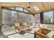 Inviting screened porch with comfortable seating, a ceiling fan, skylights, and a cozy ambiance at 1600 Patterson Grove Rd, Apex, NC 27502
