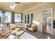 Relaxing screened porch with wood floors, skylights, a ceiling fan, and comfortable seating at 1600 Patterson Grove Rd, Apex, NC 27502