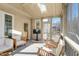 Comfortable screened porch with wood furniture, a ceiling fan, and skylights, perfect for relaxing at 1600 Patterson Grove Rd, Apex, NC 27502