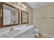 Well-lit bathroom with double sink vanity and shower at 1614 W Cotton Gin Dr, Clayton, NC 27527