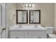 Bright bathroom with dual sinks, framed mirrors, and shower at 1614 W Cotton Gin Dr, Clayton, NC 27527
