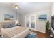 Bedroom featuring neutral walls, hardwood floors, ceiling fan, and a large window with natural light at 1614 W Cotton Gin Dr, Clayton, NC 27527