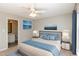This bright bedroom features a ceiling fan, neutral walls, and an ensuite bathroom at 1614 W Cotton Gin Dr, Clayton, NC 27527