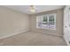 Comfortable bedroom with neutral tones, carpeted floor, ceiling fan and bright window at 1614 W Cotton Gin Dr, Clayton, NC 27527