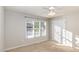 Bright bedroom with plush carpet, ceiling fan, and large window at 1614 W Cotton Gin Dr, Clayton, NC 27527