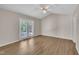 Sunlit bedroom with ceiling fan and access to outdoor patio at 1614 W Cotton Gin Dr, Clayton, NC 27527