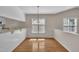 Open dining area with hardwood floors, neutral walls, and a window at 1614 W Cotton Gin Dr, Clayton, NC 27527