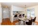Dining room featuring hardwood floors, natural light, kitchen access, and seating for six at 1614 W Cotton Gin Dr, Clayton, NC 27527